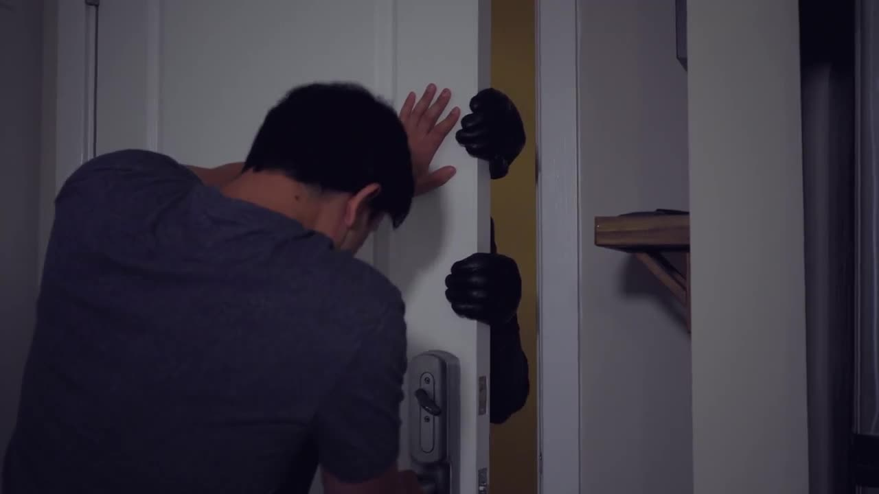 A man struggles to close a door